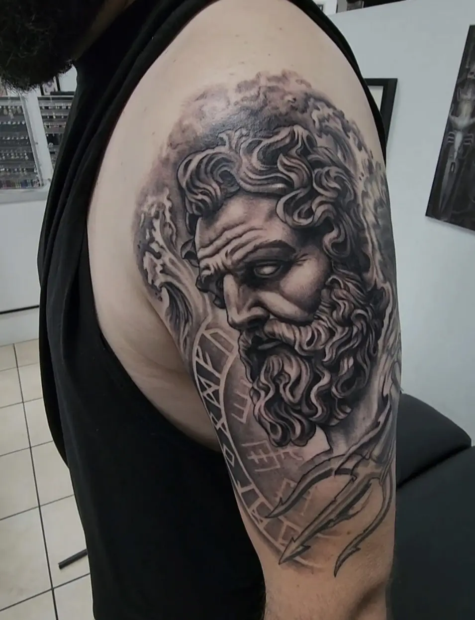 A man with a beard and tattoos on his arm