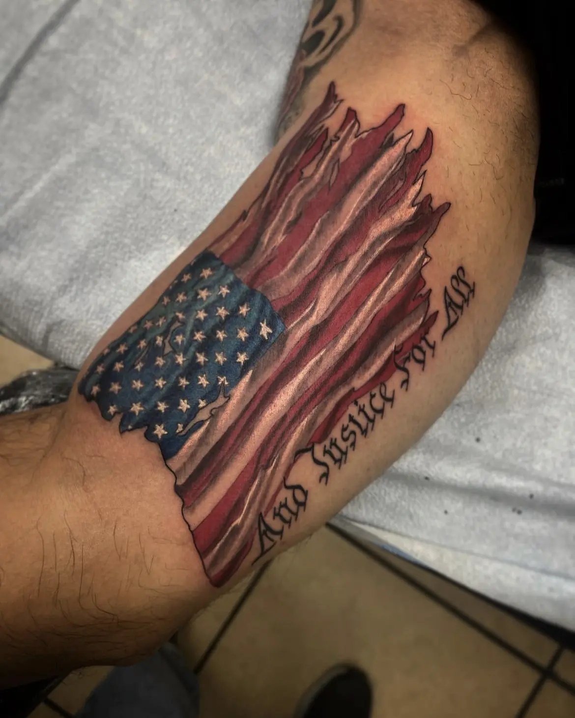 A man with an american flag tattoo on his arm.