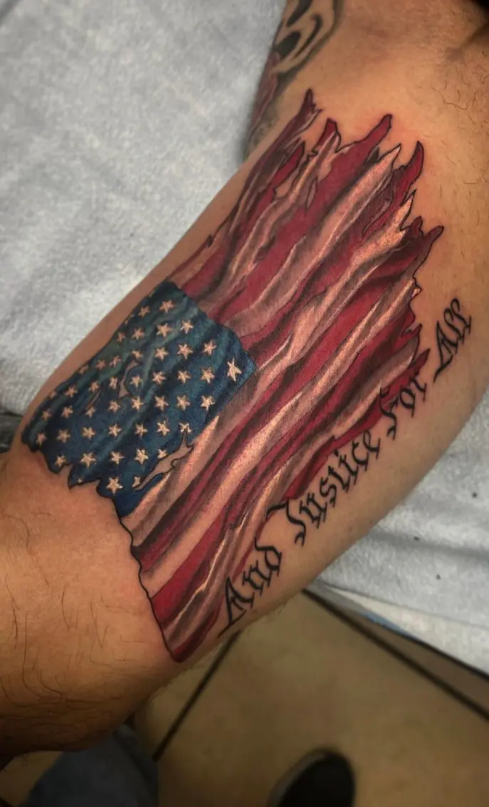 A man with an american flag tattoo on his arm.
