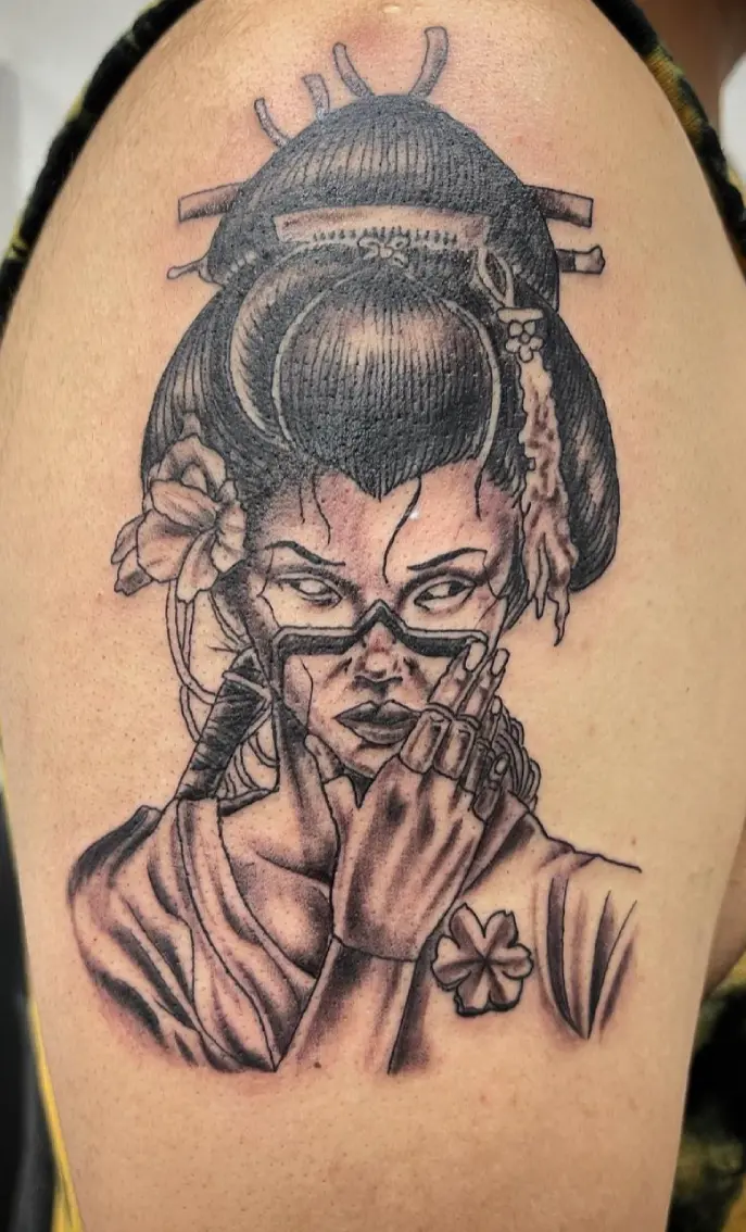 A woman with glasses and a flower in her hair.