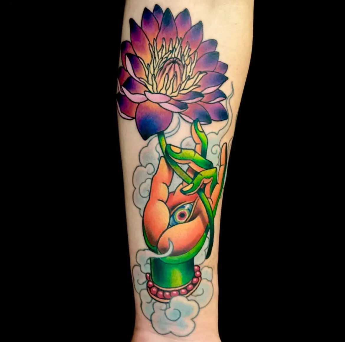 A tattoo of a hand holding a flower