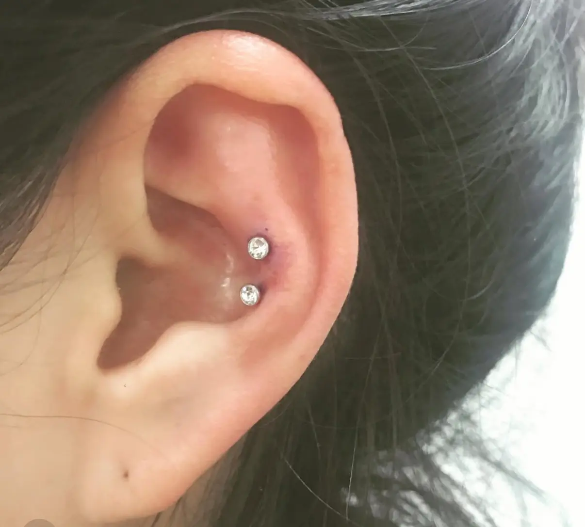 A person with their ear pierced.